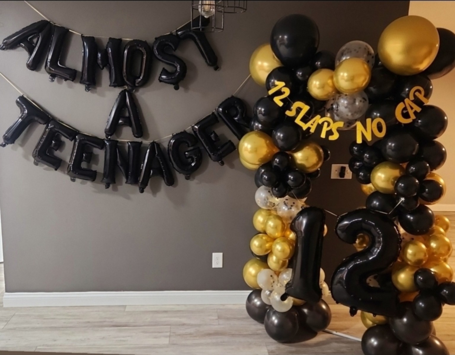 Personalized black and gold birthday balloon setup